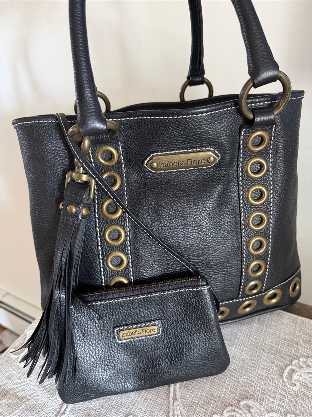 Isabella Fiore Black Leather Tote with Gold-Tone Grommet Detail and Tassel